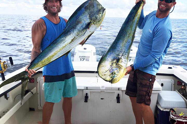a man holding a fish on a boat