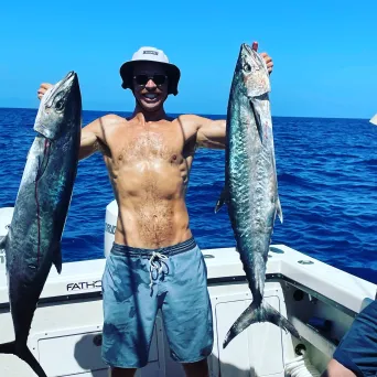 a man holding a fish in the water