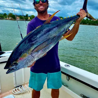 a man holding a fish in the water