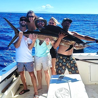 a group of people on a boat posing for the camera