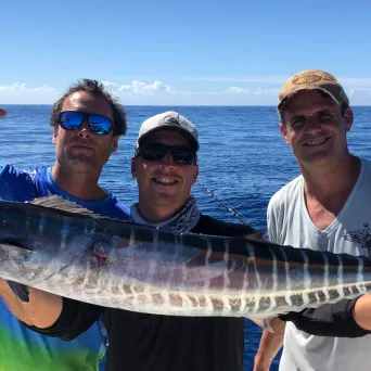 a person holding a fish in the water